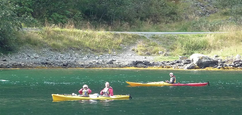 Kayaking in calm tranquil waters on a sunny day Kayaking in calm tranquil waters on a sunny day